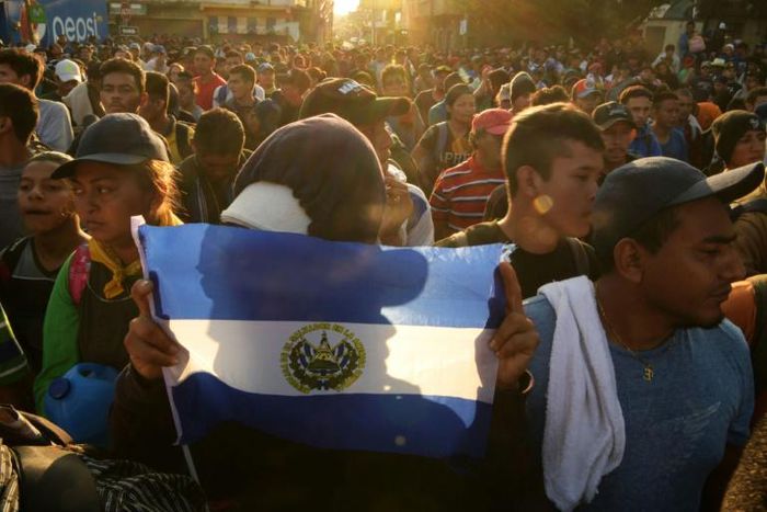 Migrants with an El Salvador flag headed to the United States