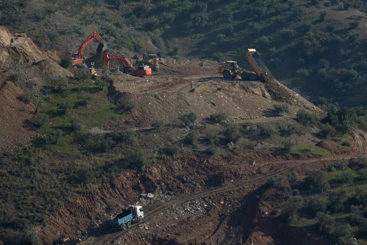 After abandoning an initial plan to reach the boy with an angled tunnel because of repeated collapses and landslides, workers turned to the possibility of drilling a vertical shaft parallel to the well