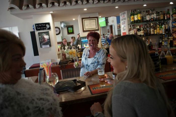 People drink in a bar in Benalmadena, southern Spain, in March 2017 -- Spain is the number one destination for British nationals living outside Britain, ahead of France and Ireland