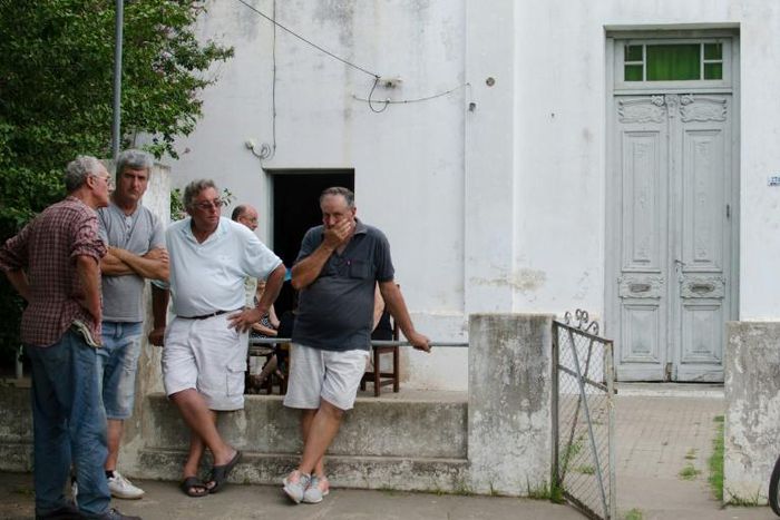 Friends and neighbors console Emiliano Sala's father Horacio Sala (2-R) in front of his house in Progreso, Santa Fe province, Argentina