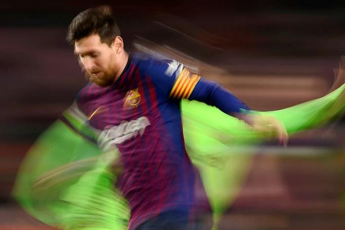 Lionel Messi ghosts past a Levante player