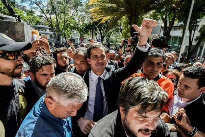 Venezuelan opposition leader Juan Guaido (C), head of the National Assembly and self-declared 'acting president,' is seen in a crowd of supporters after a rally in Caracas on January 25, 2019