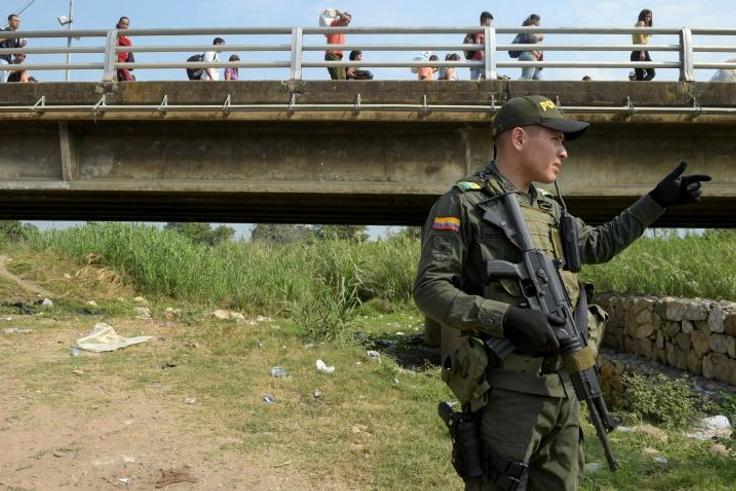 A Colombian policeman stands guard under the Simon Bolivar International Bridge, on the border between Tachira, Venezuela and Cucuta, Colombia, on February 7, 2019