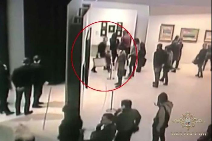 An image grab taken from a video footage released by the Russian Interior Ministry shows a man, stealing a painting by Arkhip Kuindzh at Moscow's Tretyakov Gallery
