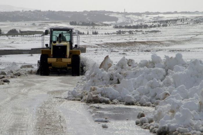 Local authorities clear a road blocked by snowfall in Tunisia, on January 25, 2019