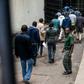 In unprecedented scenes, suspects have been hauled into court by the truckload, then denied bail and immediately put on trial in many cases -- some before they are given access to lawyers
