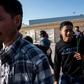 Asylum seekers from Central America walk past journalists after returning to Tijuana, Mexico from the United States while their cases are processed by US authorities, under a new policy which Amnesty International says violates international law