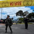 Colombian security forces stand guard outside a police cadet training academy in Bogota, the site of a deadly car bomb attack blamed on ELN rebels