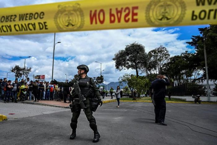 Colombian security forces stand guard outside a police cadet training academy in Bogota, the site of a deadly car bomb attack blamed on ELN rebels