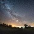 The milky way and meteors of the April Lyrids annual meteor shower in the night sky over the Baltic Sea