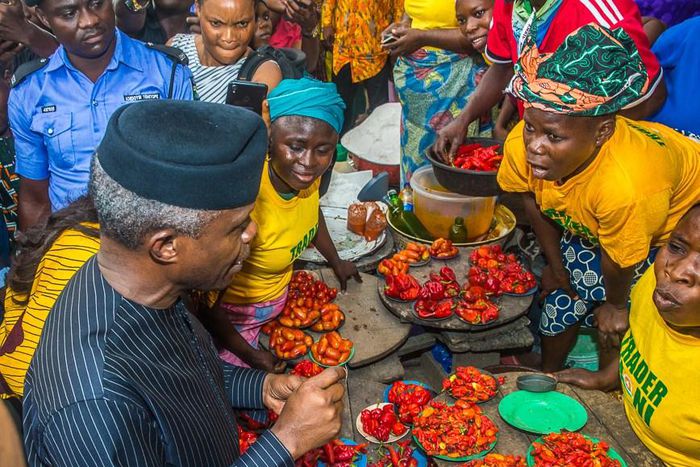 Vice-President Yemi Osinbajo sits with beneficiaries of the TraderMoni loan scheme in a market in Ibadan, Oyo State. [Premium Times]