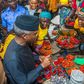 Vice-President Yemi Osinbajo sits with beneficiaries of the TraderMoni loan scheme in a market in Ibadan, Oyo State. [Premium Times]