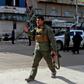 A member of Manbij's security forces patrols the site of a suicide attack targeting US-led coalition forces in the flashpoint northern Syrian city