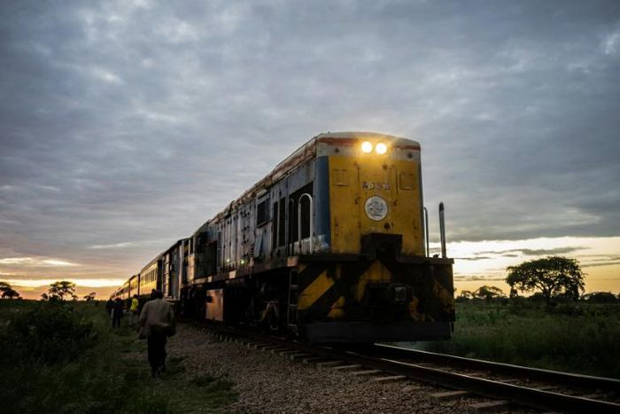 The commuter train known as the 'Freedom Train' nears a station in Cowdray Park township, Bulawayo, as dawn light rises on a late January day