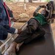 A man is loaded into a car after allegedly being assaulted on Wednesday by soldiers in Bulawayo's Sizinda township