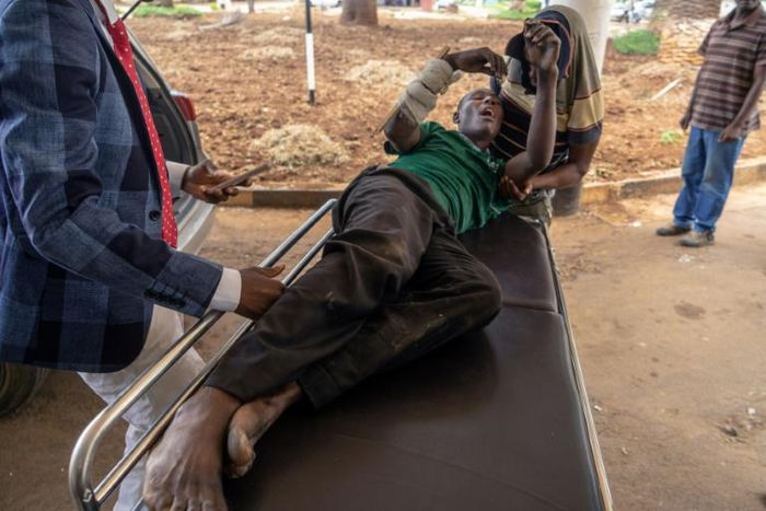 A man is loaded into a car after allegedly being assaulted on Wednesday by soldiers in Bulawayo's Sizinda township