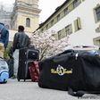 Two African migrants wait with their luggage in front of a German guesthouse Alliance/DPA/F. Kastle