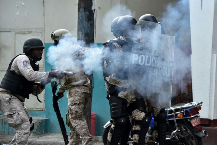 Haitian police shoot tear gas during clashes in central Port-au-Prince on February 12, 2019 during protests against Haitian President Jovenel Moise