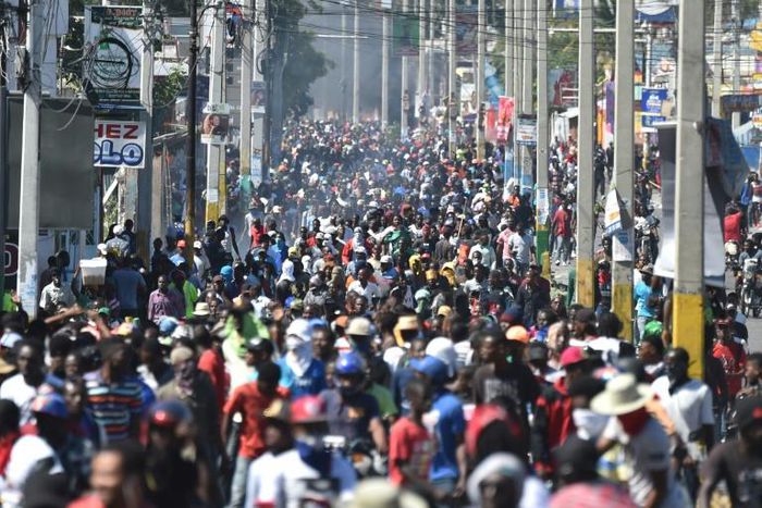 Demonstrators march on the streets of Port-au-Prince against Haitian President Jovenel Moise and the misuse of development funds on February 11, 2019