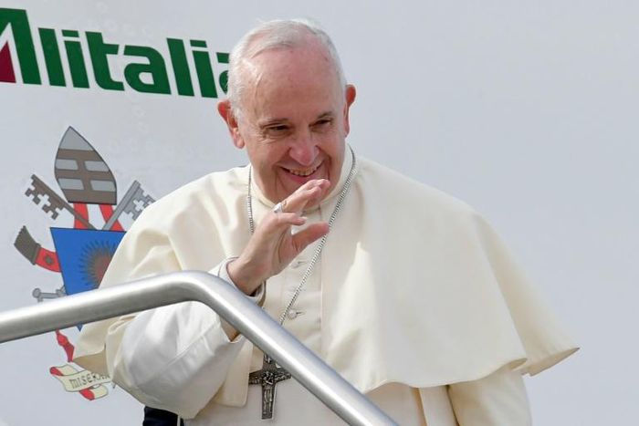 Pope Francis waves as he boards a plane at Rome's Fiumicino airport on February 3, 2019, on his way to the United Arab Emirates
