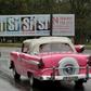 Cars in Havana pass a sign calling for a "yes" vote in the referendum on Cuba's new Constitution