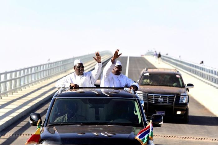 Senegal's president Macky Sall (L) and Gambian President Adama Barrow (R) wave as they inaugurate the Senegambia Bridge built to facilitate trade and travel in this part of West Africa