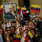 Supporters of Venezuelan President Nicolas Maduro, seen in 2016, brandish a picture of late Cuban leader Fidel Castro the day after his death