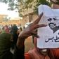A Sudanese protester carries a portrait of President Omar al-Bashir with Arabic writing that reads "down and that is all" during an anti-government demonstration east of the capital Khartoum on February 8, 2019