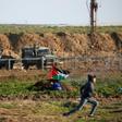Palestinian protesters take cover during a demonstration along the demarcation line with Israel, east of Gaza City, on January 18, 2019