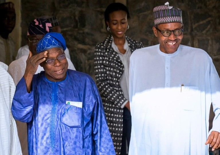 Happier times: Obasanjo, left, chats with Buhari, then president-elect, after the 2015 elections