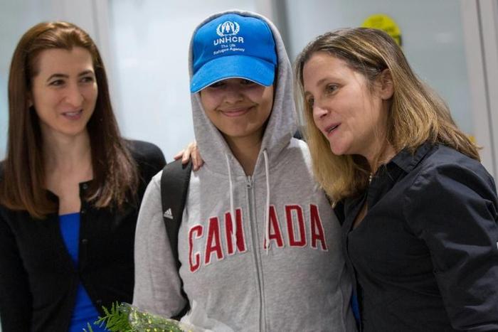 Saudi teenager Rahaf Mohammed al-Qunun (C) is welcomed by Canadian Minister for Foreign Affairs Chrystia Freeland (R) as she arrives at Pearson International airport in Toronto, Ontario, on January 12, 2019