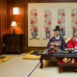 A korean couple pose for pictures at their wedding ceremony