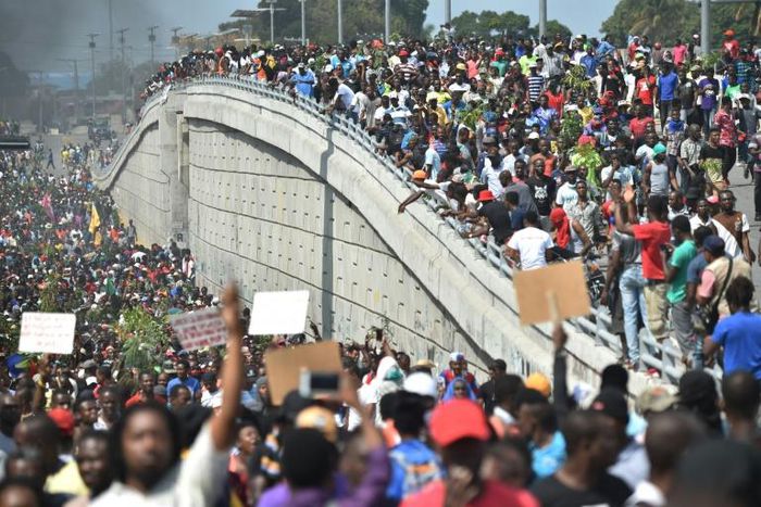 Demonstrators march through the streets of Port-au-Prince, on February 7, 2019