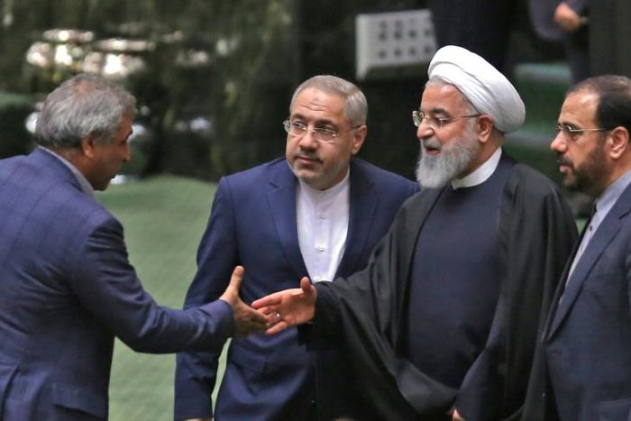 Iranian lawmakers greet President Hassan Rouhani (2nd-R) in the capital Tehran on February 4, 2019.