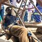 Artisanal miners known as "makorokoza" have arranged wooden logs around pits in makeshift attempts to help with the rescue operation