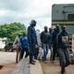 Zimbabwean anti-riot police forces watch men arrested during violent protests triggered by a sudden rise in fuel prices announced by Zimbabwean president, before their hearing at the Law Court in Harare on January 16, 2019