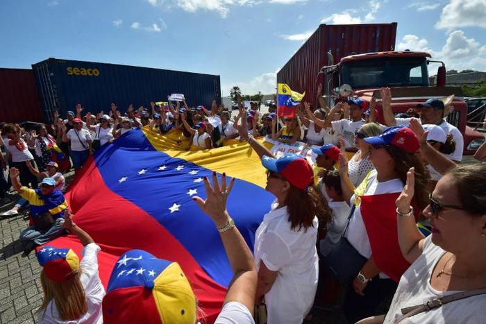 Flag-waving Venezuelan opposition supporters rallied on February 23, 2019 in the port of Willemstad, Curacao, where red trucks carried aid intended for Venezuela