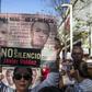 A woman holds a sign reading, "Justice for all. No to silence" as journalists, friends and relatives pay tribute to slain Mexican journalist Javier Valdez in May 2018