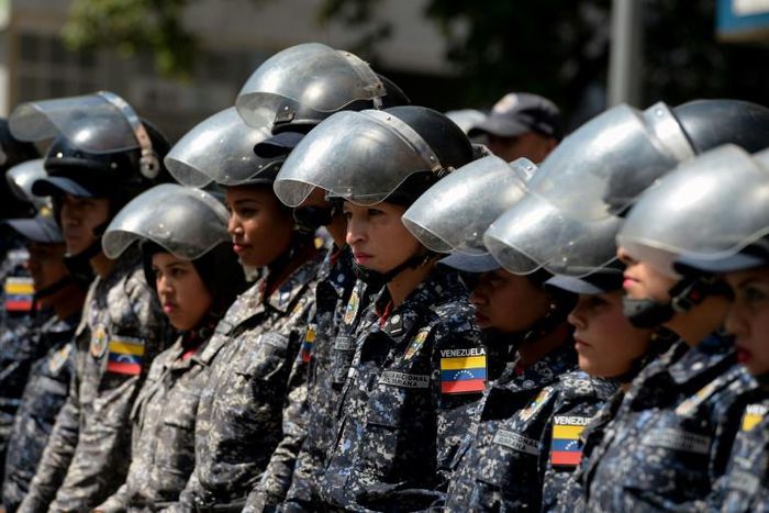 Members of the Bolivarian National Police stand guard in Caracas, during a protest against the government of President Nicolas Maduro on January 30, 2019