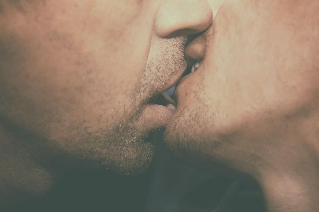 Gay couple. Kiss. Love and relationships.