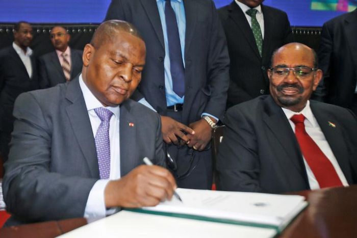 President Faustin Archange Touadera initials the peace agreement his government reached in Khartoum with 14 armed groups