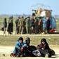 At least 300 women and children, mostly Iraqi, had slept amid the desert scrubs after escaping the Islamic State group's final redoubt of Baghouz in eastern Syria
