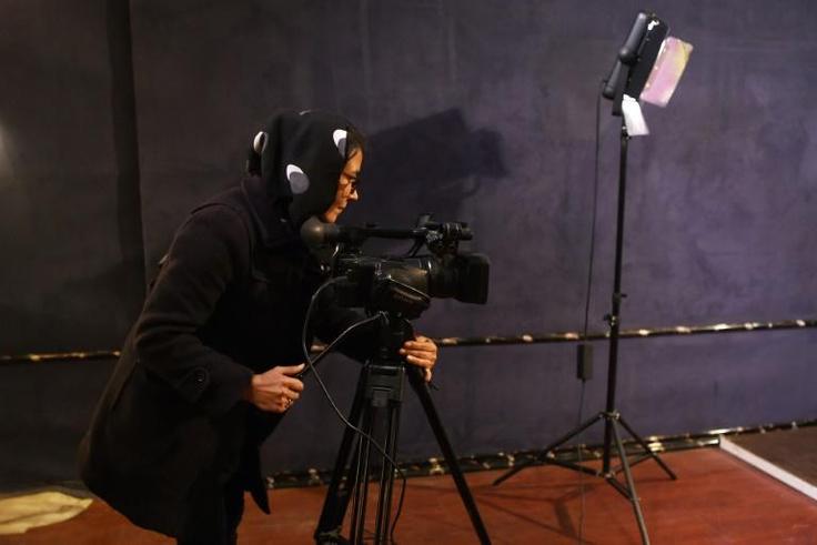 An Afghan camerawoman films for the Zan TV (Women's TV) station in Kabul. Under the Taliban women were barred from almost all employment and television was banned