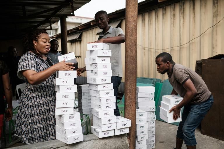 Ready? Voting staff check portable readers of biometric identity cards ahead of Saturday's postponed election