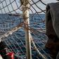 Migrants watch a vessel of the Italian coast guards from the Dutch-flagged rescue ship Sea Watch 3, as 47 migrants including minors, are stranded aboard the vessel anchored off Syracuse, Sicily, on January 26, 2019