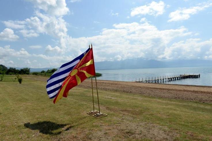 The flags of Greece and Macedonia flutter on the shores of Lake Prespa where last June's historic name deal was signed