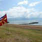 The flags of Greece and Macedonia flutter on the shores of Lake Prespa where last June's historic name deal was signed