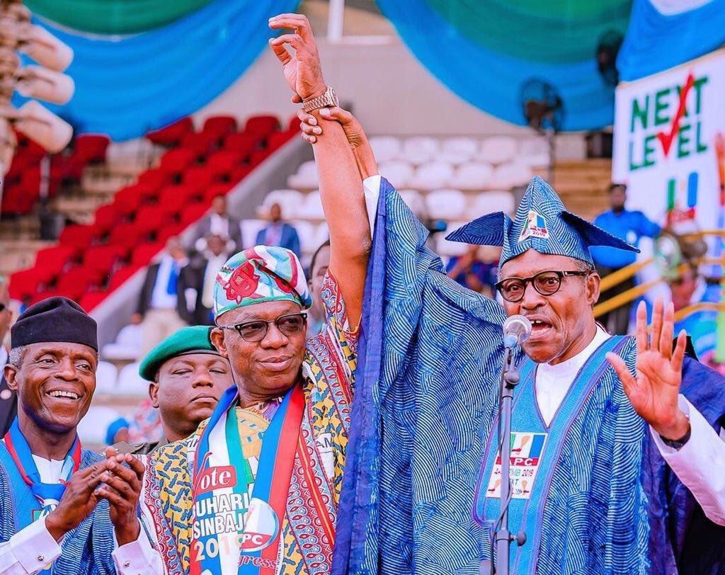 President Muhammadu Buhari (right) raises the hand of Dapo Abiodun (centre) with Vice President Yemi Osinbajo (left) looking on [Twitter/@raufaregbesola]