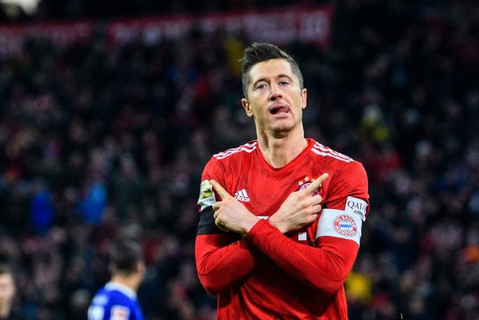 Robert Lewandowski celebrates scoring his 100th goal at the Allianz Arena in Bayern colours