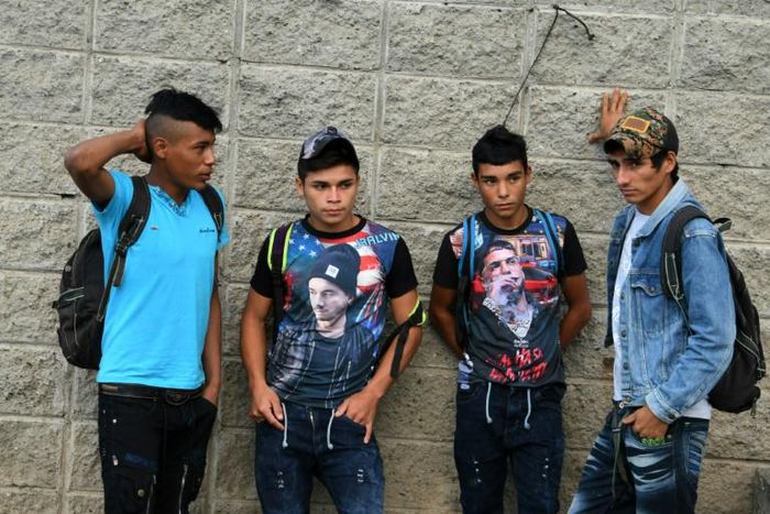 Hondurans bound for the US gather outside a bus station in San Pedro Sula, 180 km north of the capital Tegucigalpa
